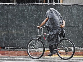 A cyclist tries to stay dry.