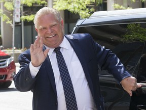 Ontario Premier-designate Doug Ford arrives at the Postmedia offices in Toronto for an interview with the Toronto Sun and greets supporters on his way into the building on Friday June 8, 2018. Ford only said he would talk to his team about the issue in the days and weeks to come.