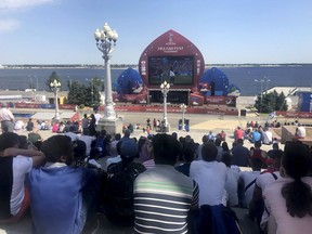 People watch the match between France and Australia at the Fan Fest on the bank of the river Wolga during the 2018 soccer World Cup in Volgograd, Russia, Friday, June 8, 2018.