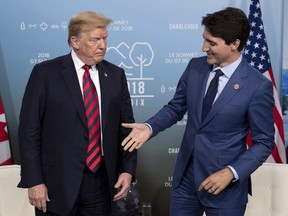 Canada's Prime Minister Justin Trudeau shakes hands with U.S. President Donald Trump during a meeting at the G7 leaders summit in La Malbaie, Que., on Friday, June 8, 2018.