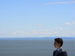 Prime Minister Justin Trudeau waits to welcome the representatives of the Outreach Countries and International Organizations at the G7 Leaders Summit in La Malbaie, Que., on Saturday, June 9, 2018.