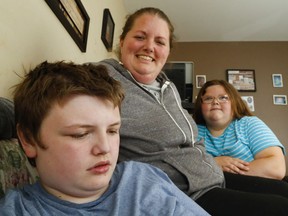 Ashley Wright sits with her son, Logan, 13, who has autism spectrum disorder, and daughter, Brinlee, 11, at their home Thursday, June 14, 2018 in Belleville, Ont.