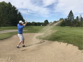 Daniel Denofsky plays a bunker shot on the 18th hole at Carleton Golf and Yacht Club on Friday during the Ottawa Citizen Golf Championship.
ANDY RAJHATHY PHOTO