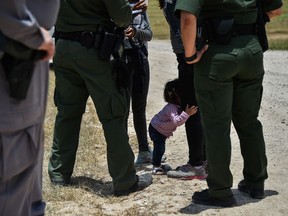 Karina Lopez's one-year-old daughter hugs her mother after they were detained by Border Patrol agents in McAllen, Texas, last June.