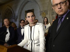 Minister of Science, Sport and Persons with Disabilities Kirsty Duncan and Parliamentary Secretary for Sport and Persons with Disabilities Stephane Lauzon listen to questions from reporters during an announcement on the elimination of harassment, abuse and discrimination in sport in the Foyer of the House of Commons on Parliament Hill in Ottawa on Tuesday, June 19, 2018.