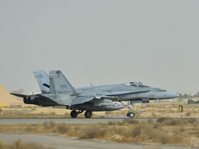 A Royal Canadian Armed Forces CF-18 Hornet fighter jet from 4 Wing Cold Lake, Alberta lands in Kuwait after the first combat mission over Iraq in support of Operation IMPACT on October 30, 2014. The Liberal government has promised to replace the CF-18 fighter jet fleet with 88 new planes. It is also buying 18 Australian F-18 jets to augment the CF-18s until the new aircraft are acquired.