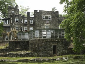 This May 5, 2004 photo shows the Tiedemann Castle in Greenwood Lake, N.Y., owned by former New York Yankees star Derek Jeter. The property features a 6-foot (1.8-meter) stone wall, a turret, an infinity pool, a lagoon and a small Statue of Liberty replica. It is on the market for $14.75 million.