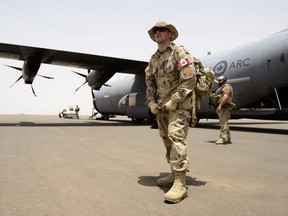 A Canadian soldier looks on as the first Canadian troops arrive at a UN base in Gao, Mali, on Sunday, June 24, 2018.