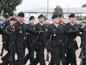 Members of the Royal Canadian Dragoons march past their senior serving general during change of command ceremonies on Thursday. The unit has been reeling after Trooper Samuel Christiansen lost his life in the Ottawa River last Friday night.