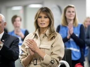 First lady Melania Trump, center, accompanied by Vice President Mike Pence, left, applauds as President Donald Trump speaks to employees at the Federal Emergency Management Agency Headquarters, Wednesday, June 6, 2018, in Washington.
