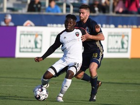 The Ottawa Fury's Adonijah Reid keeps himself between North Carolina's Graham Smith and the ball in a USL game on Wednesday, June 13, 2018 in Cary, N.C. Rob Kinnan/NCFC