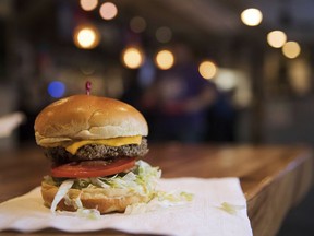 FILE- This Jan 9, 2018 photo shows the Impossible Burger at Stella's, in Bellevue, Neb., which is a burger is made from plant protein. What gets to be considered "meat" is a particularly touchy subject as startups push to alter American eating habits with substitutes they say are just like the real thing. Impossible Burger's plant-based patty "bleeds" like beef.