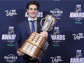 Mathew Barzal of the New York Islanders poses with the Calder Trophy after winning the award at the NHL Awards, Wednesday, June 20, 2018, in Las Vegas.