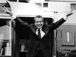 FILE - In this Aug. 9, 1974 file photo, Richard Nixon waves goodbye with a salute to his staff members outside the White House as he boards a helicopter and resigns the presidency on Aug. 9, 1974. In that same year, President Gerald Ford pardoned Richard Nixon, for all federal crimes Nixon "may or may not" have committed during his time as president.