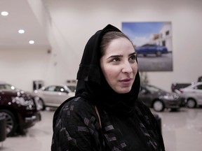 In this June 21, 2018 photo, Nour Obeid looks at cars at the Al-Jazirah Ford showroom in Riyadh, Saudi Arabia. This Sunday, Saudi Arabia will lift the world's only ban on women driving and Obeid's husband is encouraging her to get her license and drive.