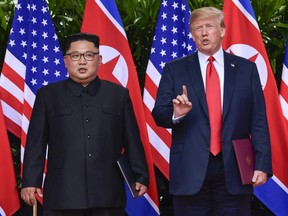 In this June 12, 2018, file photo, U.S. President Donald Trump makes a statement before saying goodbye to North Korea leader Kim Jong Un after their meetings at the Capella resort on Sentosa Island in Singapore.