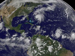 FILE - This image made available by the NOAA-NASA GOES Project shows tropical weather systems Hurricane Norma, left, on the Pacific Ocean side of Mexico; Jose, center, east of Florida; Tropical Depression 15, second from right, north of South America, and Tropical Storm Lee, right, north of eastern Brazil, on Saturday, Sept. 16, 2017. During the past 30 years since 1988, there have been more major hurricanes _ those with winds of more than 110 mph _ on average, they've lasted longer and produced more energy than the previous 30 years, according to an Associated Press analysis of storm data. (NOAA-NASA GOES Project via AP, File)