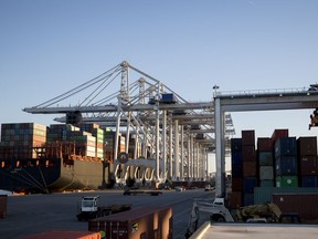 FILE- This Jan. 30, 2018, file photo shows cranes at the Georgia Ports Authority's Port of Savannah loading and unloading containers in Savannah, Ga.