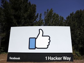 FILE- This March 28, 2018, file photo shows the Facebook logo at the company's headquarters in Menlo Park, Calif. Facebook says it will fund exclusive news shows created for its Watch video section by publishers such as ABC, CNN and Mic.