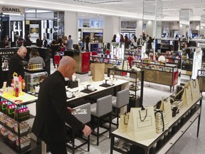 This May 22, 2018, photo a partial view of various vendors on the revamped second floor devoted to beauty at Saks Fifth Avenue in New York. Stores like Saks and Macy's are promising workouts for your face, augmented reality and beauty treatment concierges as they try to attract millennial customers and make the cosmetics aisles more of a destination than a stopover.