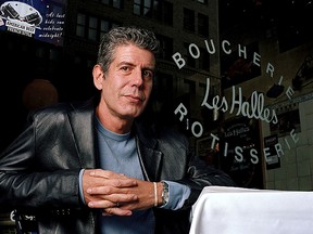 This Dec. 19, 2001 file photo shows Anthony Bourdain, the owner and chef of Les Halles restaurant, sitting at one of the tables in New York.