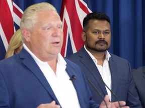 Ontario PC leader Doug Ford speaks as candidate Roshan Nallaratnam (right) looks on during a campaign announcement in Toronto on Monday, June 4, 2018.