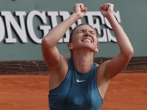 Romania's Simona Halep celebrates wining the final match of the French Open tennis tournament against Sloane Stephens of the U.S. in three sets 3-6, 6-4, 6-1, at the Roland Garros stadium in Paris, France, Saturday, June 9, 2018.
