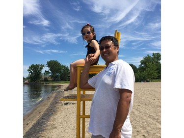 Jason Ding and his daughter, Julianna, soak up the sun at Britannia Beach.