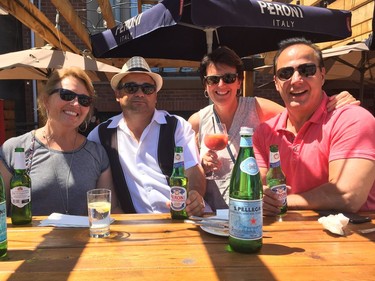 Visitors from Kingston, from left, Wendy DeLonghi, Tony DeLonghi, Mary Francis Irving and Ian Irving score street-side seats while awaiting the Ferrari parade at Italian Week.