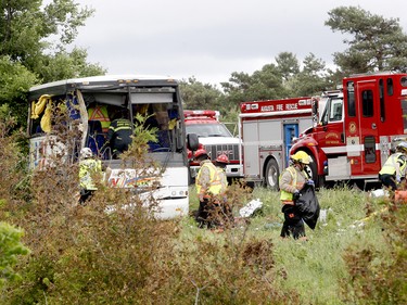 Firefighters and police officers respond to a serious collision involving a bus west of Prescott on Highway 401 on Monday, June 4, 2018 near Prescott, Ont. (MARSHALL HEALEY/Special to The Recorder and Times)