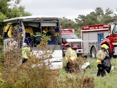 Firefighters and police officers respond to a serious collision involving a bus west of Prescott on Highway 401 on Monday, June 4, 2018 near Prescott, Ont. (MARSHALL HEALEY/Special to The Recorder and Times) ORG XMIT: POS1806042101401369