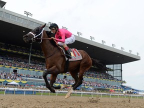 Wonder Gadot, with jockey John Velazquez aboard. races toward the finish line in the Queen's Plate at Woodbine Racetrack on Saturday.