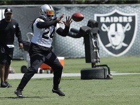 Oakland Raiders running back Marshawn Lynch catches a pass during practice at the team's NFL football training facility in Alameda, Calif., Tuesday, May 29, 2018.