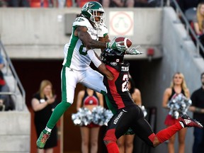 Ottawa Redblacks' Corey Tindal prevents Saskatchewan Roughriders' Naaman Roosevelt from completing a catch, during first half CFL action in Ottawa on Thursday, June 21, 2018.