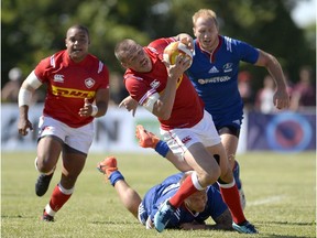 Canada's Nick Blevins (12) tries to make his way past Russia during the first half.