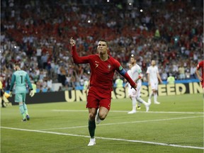 Cristiano Ronaldo celebrates after scoring Portugal's opening goal during a World Cup Group B match against Spain at Sochi on Friday.