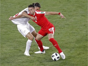 Switzerland's Ricardo Rodriguez, left, and Serbia's Dusan Tadic fight for the ball during Friday's Group E match in Kaliningrad.