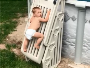 In a viral video, 2-year-old Cody Wyman scales a previously un-climbable pool ladder. (Facebook)