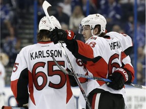 Mike Hoffman (68) celebrates with Erik Karlsson (65) after scoring for the Senators against the Lightning during a game on Feb. 2.