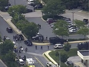 In this frame from video, people leave the Capital Gazette newspaper after multiple people have been shot on Thursday, June 28, 2018, in Annapolis, Md.