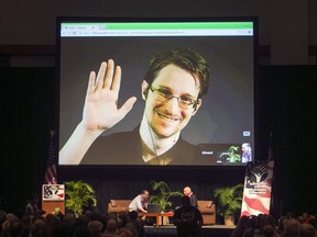 In this Feb. 14, 2015, file photo, Edward Snowden appears on a live video feed broadcast from Moscow at an event sponsored by ACLU Hawaii in Honolulu.