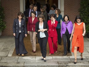Spain's new government ministers, from left; Justice Minister Dolores Delgado, Labor, Migration and Social Security Minister Magdalena Valerio, Energy and Environment Minister Teresa Ribera, Deputy Prime Minister Carmen Calvo, Defense Minister Margarita Robles and Health Minister Carmen Monton, step out for a family photograph after their first Cabinet meeting at the Moncloa palace in Madrid, Friday, June 8, 2018.