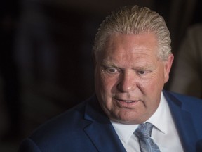 Ontario Premier-designate Doug Ford speaks to the media during a break from the first meeting of the newly-elected Ontario PC Caucus at Queen's Park in Toronto on Tuesday, June 19, 2018.