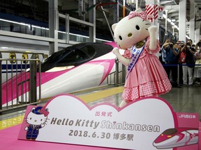 A Hello Kitty-themed "shinkansen" bullet train is unveiled at JR Shin Osaka station, in Osaka, western Japan, Saturday, June 30, 2018. The special shinkansen had its inaugural round trip Saturday between Osaka and Fukuoka, connecting Japan's west and south until the end of September. The stylish train is painted pink and white, showcasing Hello Kitty images and trademark ribbons from flooring to seat covers and windows.