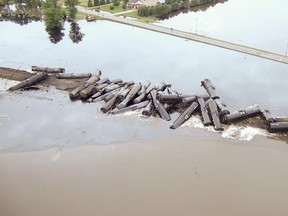 In this aerial drone image taken from video and provided by the Sioux County Sheriff's Office, tanker cars carrying crude oil are shown derailed about a mile south of Doon, Iowa, Friday, June 22, 2018. About 31 cars derailed after the tracks reportedly collapsed due to saturation from flood waters from adjacent Little Rock River. (Sioux County Sheriff's Office via AP)