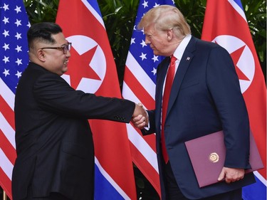 North Korea leader Kim Jong Un and U.S. President Donald Trump shake hands at the conclusion of their meetings at the Capella resort on Sentosa Island Tuesday, June 12, 2018 in Singapore.