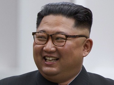 North Korean leader Kim Jong Un smiles while walking with U.S. President Donald Trump on Sentosa Island in Singapore Tuesday, June 12, 2018. Kim has a sweptback hairstyle with the sides and back shaved neatly, and experts say it's part of his efforts to model his appearance on his grandfather Kim Il Sung who founded North Korea in 1948.