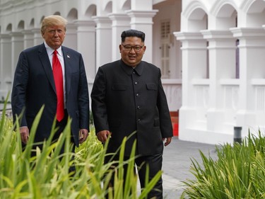 U.S. President Donald Trump walks with North Korea leader Kim Jong Un after lunch at the Capella resort on Sentosa Island Tuesday, June 12, 2018 in Singapore.