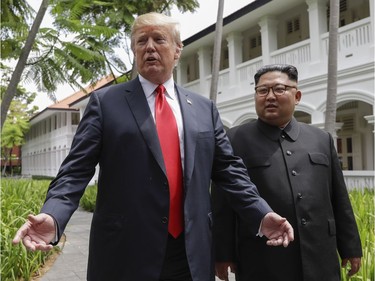 U.S. President Donald Trump and North Korea leader Kim Jong Un stop to talk with the media as they walk from their lunch at the Capella resort on Sentosa Island Tuesday, June 12, 2018 in Singapore.