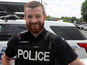 Kingston Const. Walter O'Connor was hoisted into a building building to held an elderly man escape.